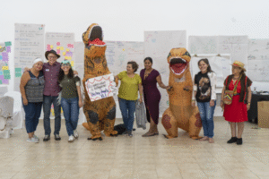 9 workshop participants group picture with two of them dressed as dinosaurs