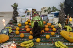 an ethnic cloth with fruits and multiple items and candles participants put together