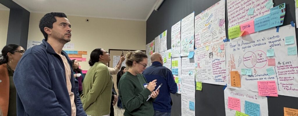 Multiple workshop participants looking and reflecting on flipcharts all participants prepared