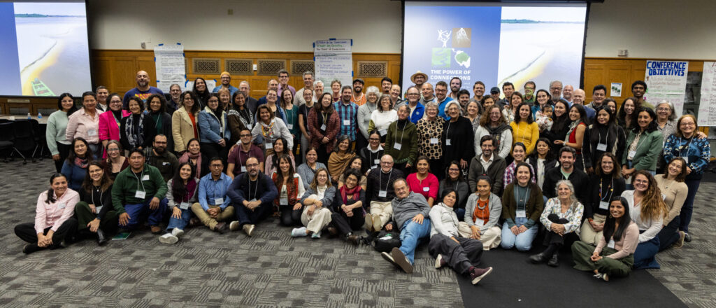 around 90 conference participants looking at the camera for official picture