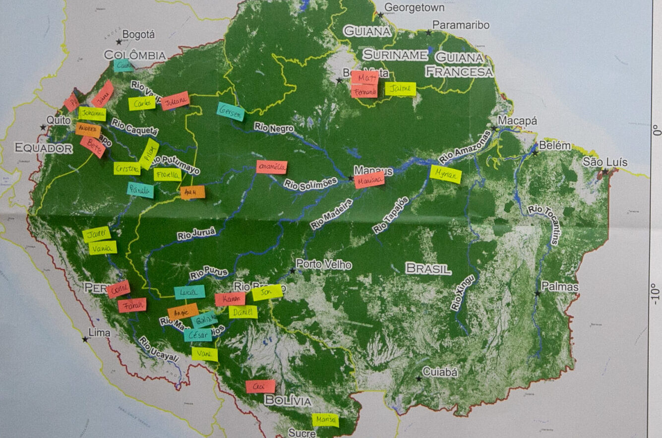 Printed map of the Amazon basin with small post it notes on them, each with names of people